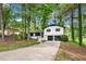 Charming split-level home boasts a two-car garage and mature trees on a lovely, landscaped lot at 671 Shannon Green Sw Cir, Mableton, GA 30126