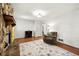 Comfortable living room with stone fireplace, hardwood floors and accent lighting at 671 Shannon Green Sw Cir, Mableton, GA 30126