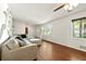 Bright living room with hardwood floors, a large window, and comfortable seating at 671 Shannon Green Sw Cir, Mableton, GA 30126