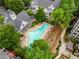 Aerial view of a community pool and clubhouse, surrounded by lush landscaping and mature trees at 951 Glenwood Se Ave # 1805, Atlanta, GA 30316