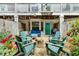Inviting backyard patio with stone pavers, a fire pit, Adirondack chairs, and string lights at 951 Glenwood Se Ave # 1805, Atlanta, GA 30316