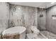 Modern bathroom featuring a soaking tub, walk-in shower, and elegant marble accents at 951 Glenwood Se Ave # 1805, Atlanta, GA 30316