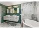 Modern bathroom features double vanity, soaking tub, and marble tile at 951 Glenwood Se Ave # 1805, Atlanta, GA 30316