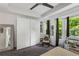 Well-lit bedroom with a large closet, seating, and natural light from the bay windows at 951 Glenwood Se Ave # 1805, Atlanta, GA 30316