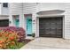Townhome exterior with a bright blue door, black garage and lovely flower bed at 951 Glenwood Se Ave # 1805, Atlanta, GA 30316