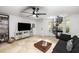 Living room featuring a spiral staircase, black sectional, tile floor, and modern fan at 951 Glenwood Se Ave # 1805, Atlanta, GA 30316