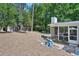 Large backyard with a patio featuring a sunroom and lots of mature trees and landscaping at 3533 Keswick Dr, Atlanta, GA 30341