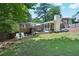Spacious backyard featuring a sunroom, deck, patio and lush lawn perfect for outdoor activities at 3533 Keswick Dr, Atlanta, GA 30341