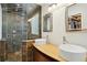 Bathroom featuring double sinks, a stone shower, and walk-in closet at 3533 Keswick Dr, Atlanta, GA 30341