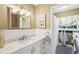 Well-lit bathroom with a marble countertop, white cabinetry, and a laundry area at 3533 Keswick Dr, Atlanta, GA 30341