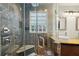 Bathroom featuring a glass-enclosed shower, double sinks, and modern fixtures at 3533 Keswick Dr, Atlanta, GA 30341