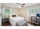 Bright bedroom featuring wood floors, a leopard print bench, and neutral decor at 3533 Keswick Dr, Atlanta, GA 30341