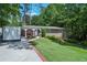 Charming brick home with manicured lawn, lush landscaping, and covered carport in a desirable neighborhood at 3533 Keswick Dr, Atlanta, GA 30341
