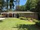 Charming brick home with manicured lawn, lush landscaping, and covered carport in a desirable neighborhood at 3533 Keswick Dr, Atlanta, GA 30341