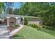 Charming brick home with manicured lawn, lush landscaping, and covered carport in a desirable neighborhood at 3533 Keswick Dr, Atlanta, GA 30341