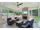 Relaxing sunroom with brick fireplace, ceiling fan, and comfortable seating for outdoor living at 3533 Keswick Dr, Atlanta, GA 30341