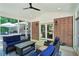 Cozy sunroom with brick accent wall, comfortable seating and fan, perfect for relaxing and entertaining at 3533 Keswick Dr, Atlanta, GA 30341