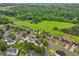 Aerial view of a neighborhood with mature trees, green space, and single-Gathering homes at 1185 Charter Club Dr, Lawrenceville, GA 30043