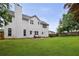 Spacious backyard showcasing a patio, lush lawn, and a privacy fence at 1185 Charter Club Dr, Lawrenceville, GA 30043