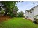 Scenic backyard featuring a beautiful lawn, mature trees, and a patio with outdoor seating at 1185 Charter Club Dr, Lawrenceville, GA 30043