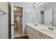 Bright bathroom with a double sink vanity, wood floors and a view into the hallway, creating an open space at 1185 Charter Club Dr, Lawrenceville, GA 30043