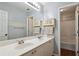 Bathroom with double sink vanity, large mirror, tub and shower with painted blue walls at 1185 Charter Club Dr, Lawrenceville, GA 30043