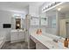 Bathroom featuring a large mirror, double vanity, tile flooring and tub with shower at 1185 Charter Club Dr, Lawrenceville, GA 30043