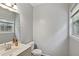 Cozy bathroom featuring a white toilet, vanity with sink, and a window providing natural light at 1185 Charter Club Dr, Lawrenceville, GA 30043