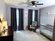 Bedroom with a comfortable rocking chair and crib at 1185 Charter Club Dr, Lawrenceville, GA 30043