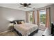 Cozy bedroom featuring a ceiling fan, carpet floors, and natural light from two windows, creating a comfortable retreat at 1185 Charter Club Dr, Lawrenceville, GA 30043