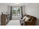 Cozy room with a comfortable couch, natural light, carpeted floor and bookshelf at 1185 Charter Club Dr, Lawrenceville, GA 30043
