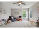 Bright bedroom featuring carpet floors, ample natural light, and colorful wall decals, perfect for a room at 1185 Charter Club Dr, Lawrenceville, GA 30043