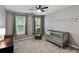 Comfortable Bedroom with a crib, rocking chair, carpet floors, and soft lighting, creating a cozy environment at 1185 Charter Club Dr, Lawrenceville, GA 30043