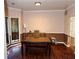 The dining room features hardwood floors, large windows, and neutral paint colors at 1185 Charter Club Dr, Lawrenceville, GA 30043