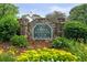 Stone entrance to Charter Club on the River with lush landscaping at 1185 Charter Club Dr, Lawrenceville, GA 30043