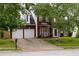 Charming two-story brick home with a well-manicured lawn and a two-car garage at 1185 Charter Club Dr, Lawrenceville, GA 30043