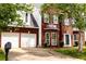 Lovely two-story brick home with an attached two-car garage and a manicured front lawn at 1185 Charter Club Dr, Lawrenceville, GA 30043