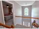Upstairs hallway with carpet and light fixture at 1185 Charter Club Dr, Lawrenceville, GA 30043