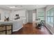 Eat-in kitchen with white cabinets, grey walls, stainless steel appliances, and wooden floors at 1185 Charter Club Dr, Lawrenceville, GA 30043