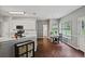 Eat-in kitchen with white cabinets, grey walls, stainless steel appliances, and wooden floors at 1185 Charter Club Dr, Lawrenceville, GA 30043