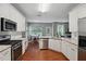 Charming kitchen with white cabinets, stainless steel appliances, and light colored marble countertops at 1185 Charter Club Dr, Lawrenceville, GA 30043