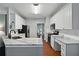 Charming kitchen with white cabinets, stainless steel appliances, and light colored marble countertops at 1185 Charter Club Dr, Lawrenceville, GA 30043