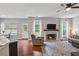 Cozy living room featuring a fireplace, windows, and a ceiling fan at 1185 Charter Club Dr, Lawrenceville, GA 30043