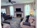 Inviting living room with fireplace, large windows, ceiling fan and plush seating at 1185 Charter Club Dr, Lawrenceville, GA 30043