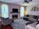 Cozy living room featuring a fireplace, large windows, and comfortable seating at 1185 Charter Club Dr, Lawrenceville, GA 30043