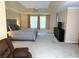 Bright main bedroom showcasing a king bed, dresser, sitting area, and large windows at 1185 Charter Club Dr, Lawrenceville, GA 30043