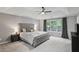 Main bedroom with large window, ceiling fan, tray ceiling, and carpeted floor at 1185 Charter Club Dr, Lawrenceville, GA 30043
