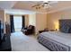Large main bedroom featuring a tray ceiling, a king-sized bed, and comfortable sitting area for relaxation at 1185 Charter Club Dr, Lawrenceville, GA 30043