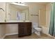 Bathroom showcasing a vanity with storage, toilet, and a tub/shower combo at 1307 Clarecastle Ln, Buford, GA 30519