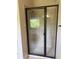 A modern bathroom featuring a tiled shower with sleek glass doors and fixtures at 1307 Clarecastle Ln, Buford, GA 30519